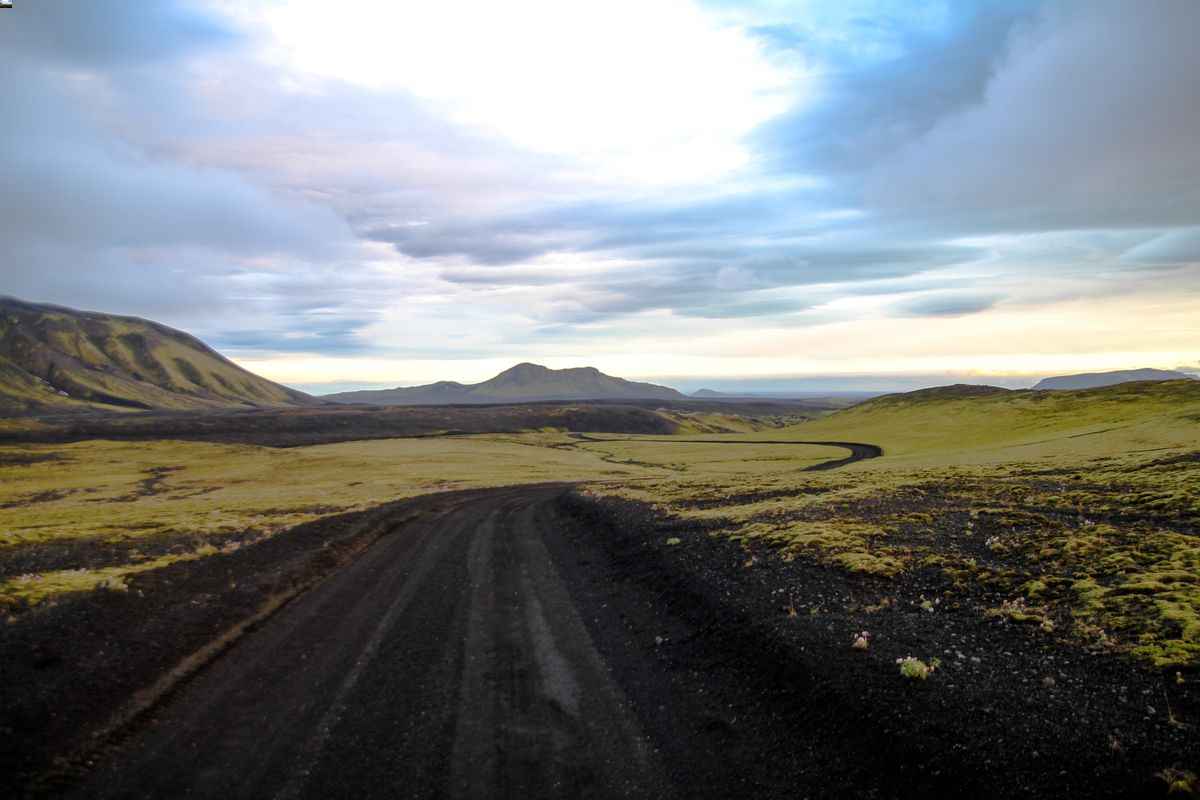 Gravel stretch of Iceland’s F206 winding across black volcanic plains.