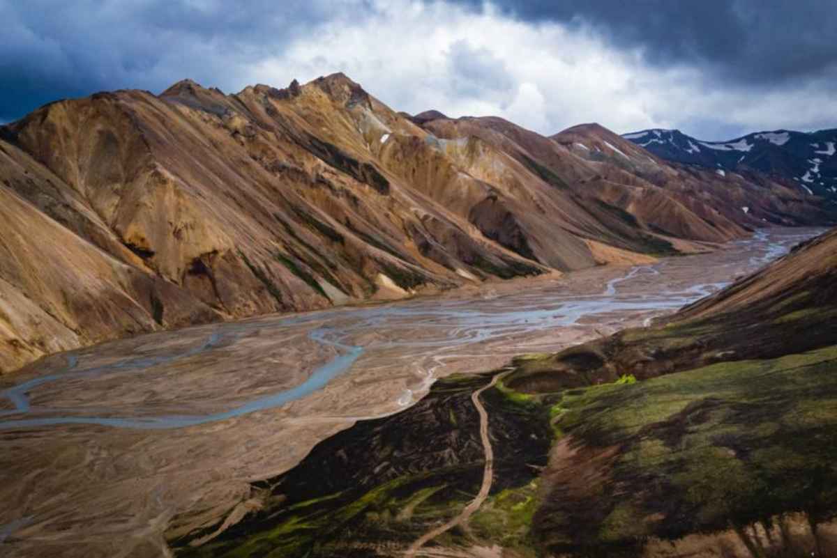 Braided glacial river valley below multicolored rhyolite mountains in Landmannalaugar along F208.