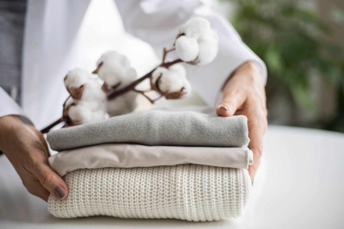 Neatly folded cotton layers with a cotton branch—soft, breathable clothing for travel.