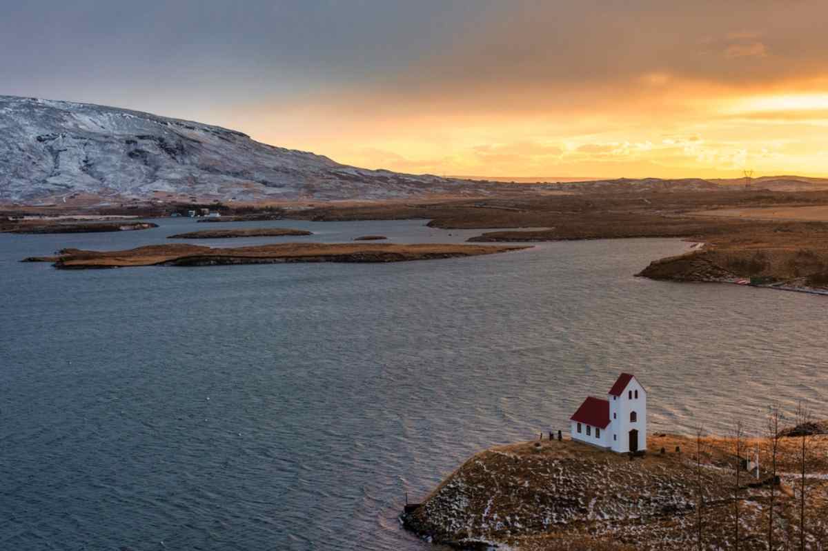 Aerial view of a church near Lake Ulfljotsvatn in Iceland at sunset.