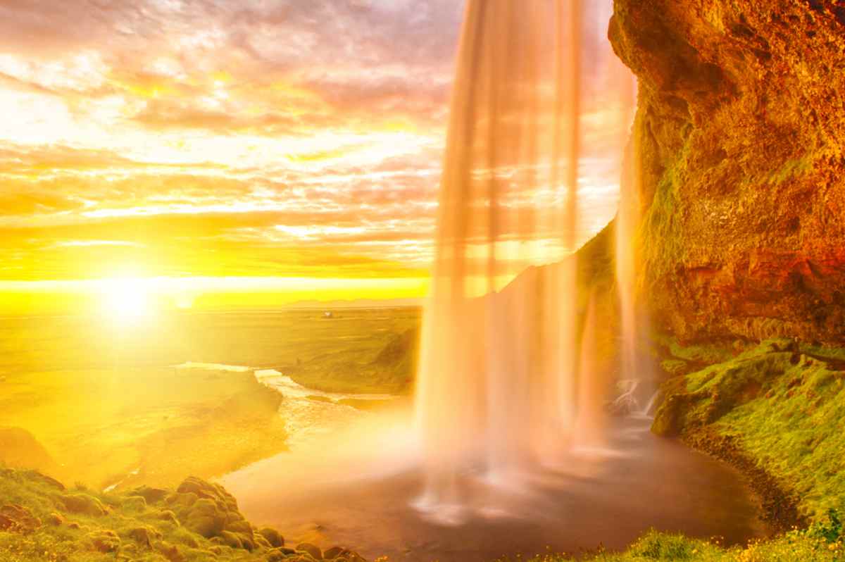 Iceland's June light completely bathes the water falling from one of its many waterfalls.