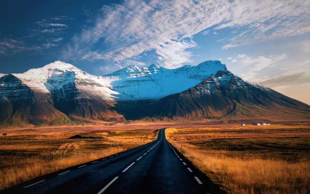 Road Leading to Snow-Capped Mountains in Iceland