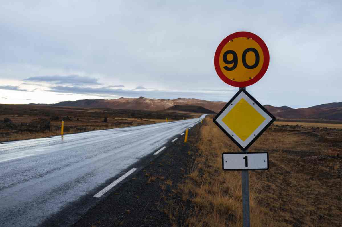 90 km/h speed limit sign beside a wet stretch of Iceland’s Ring Road.