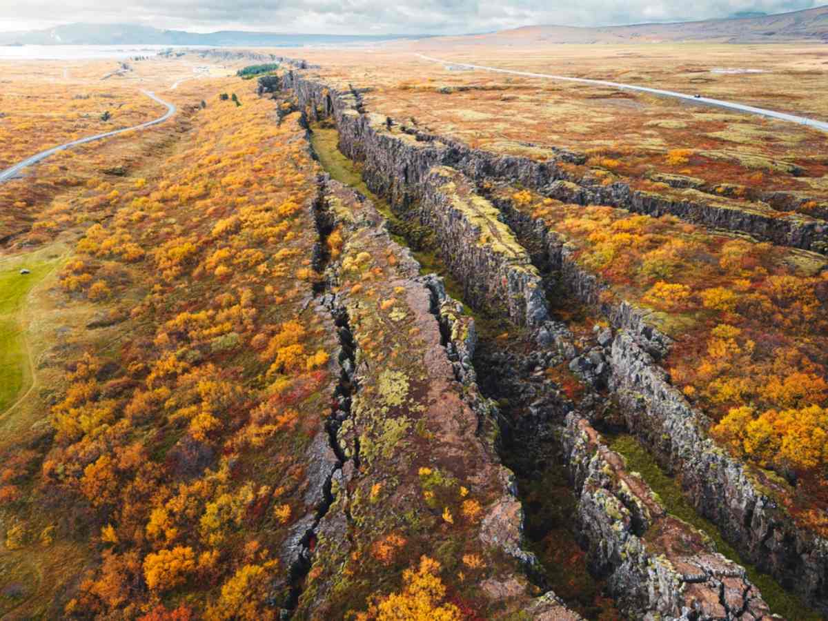 Aerial of the Almannagj&aacute; rift at &THORN;ingvellir National Park framed by autumn colors.