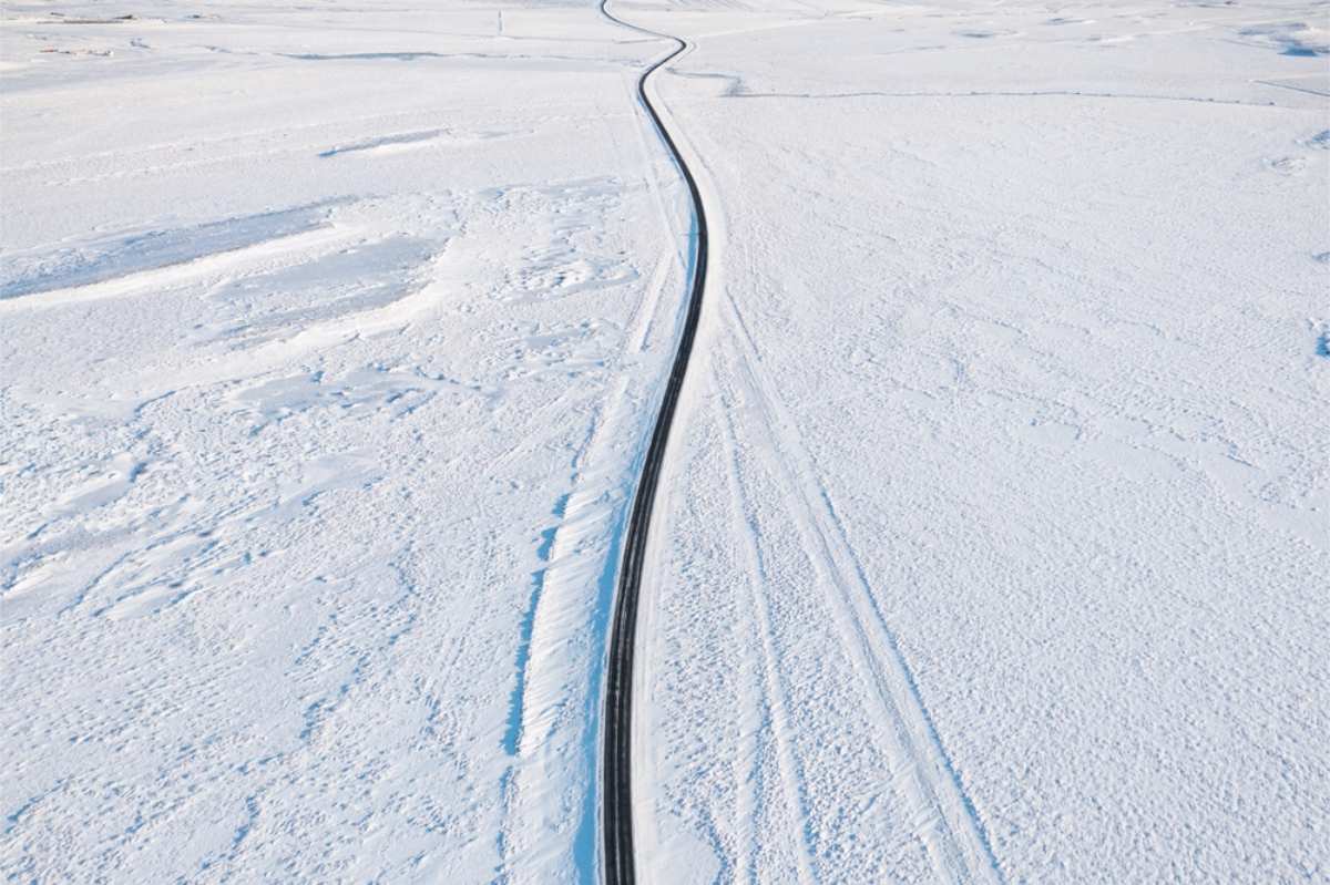 drone view of the ring road with its surroundings completely covered in snow