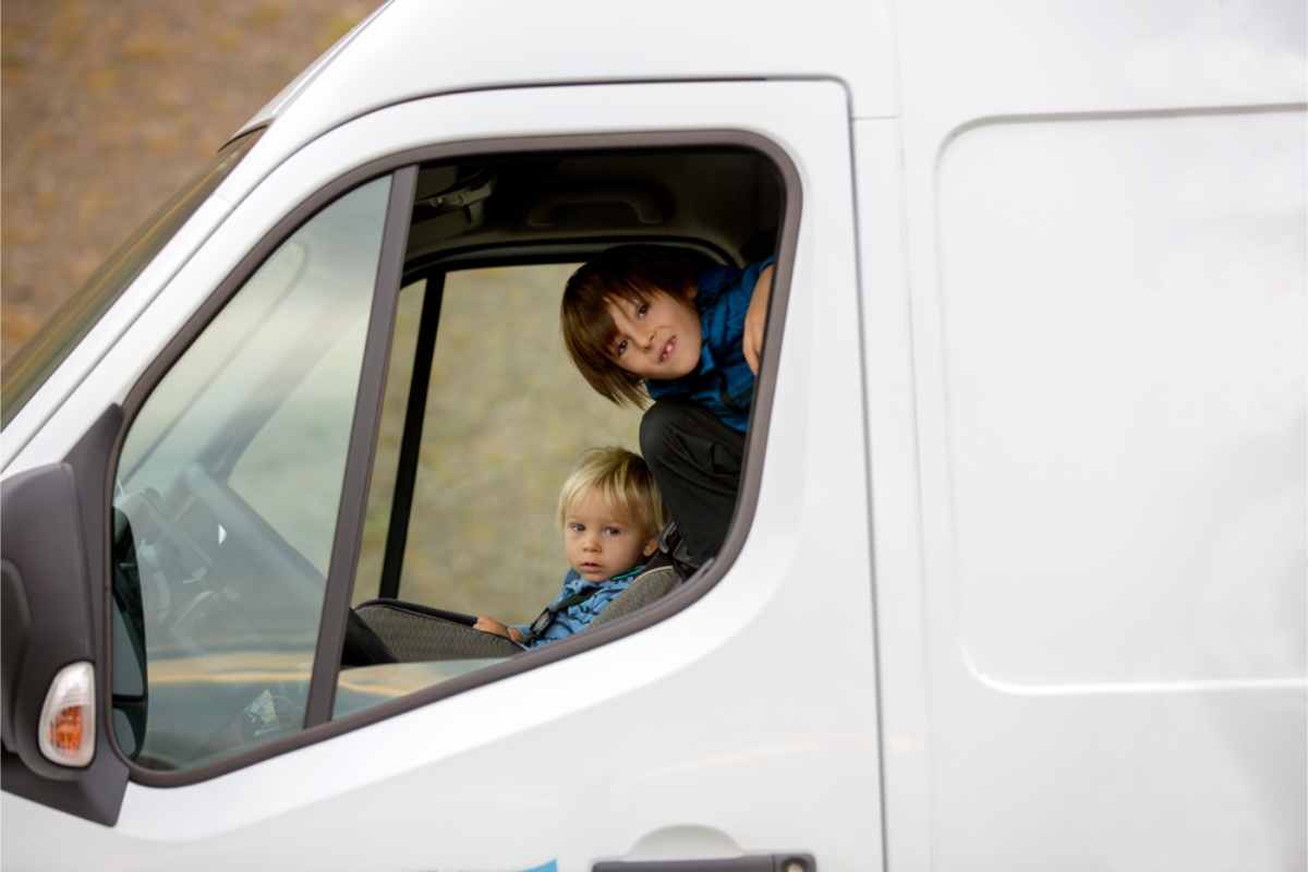 Two kids inside of a campervan in Iceland