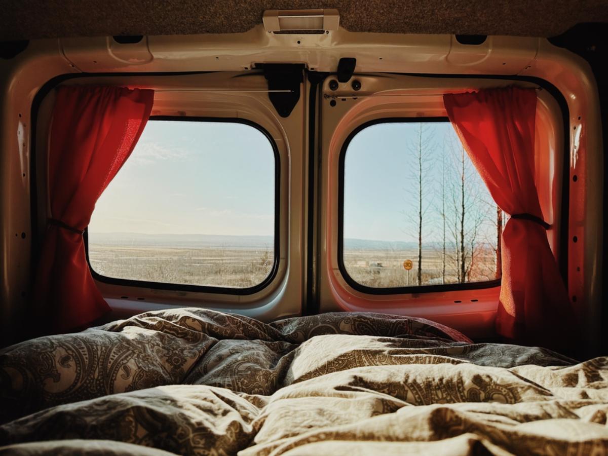 Back of a camper with the curtains drawn showing Iceland&acute;s landscape